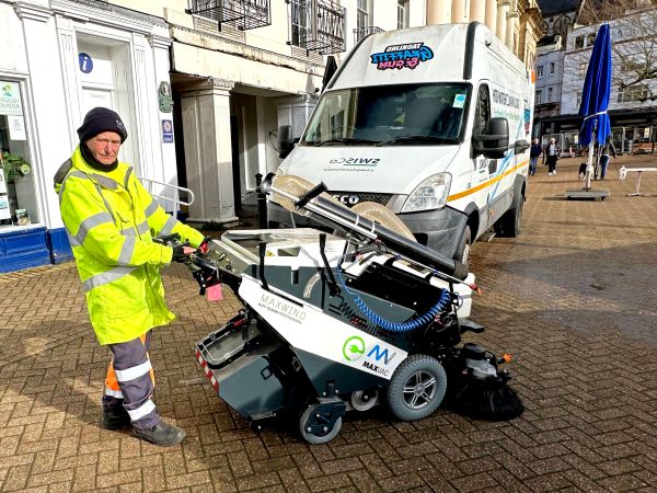 team SWISCo operative in front of a fleet vehicle with street sweeper