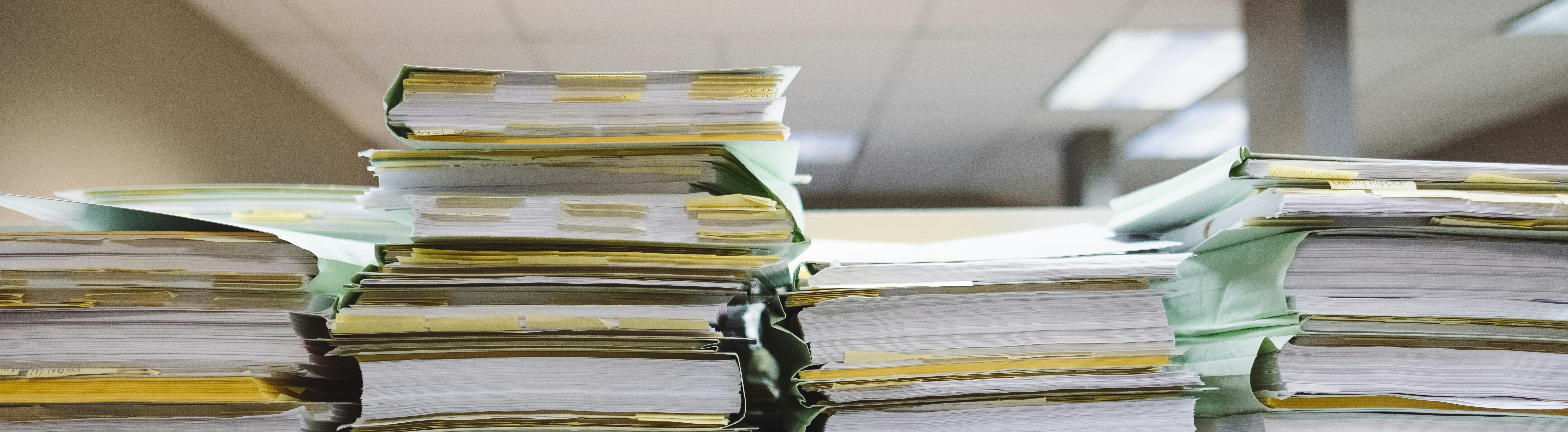 a pile of documents in an office setting