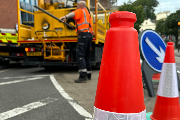 highways team next to vehicle with bollards in foreground